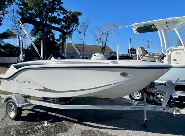 Slide: The Image of 2024 Bayliner Element M15 boat on a trailer in a parking lot. - 0