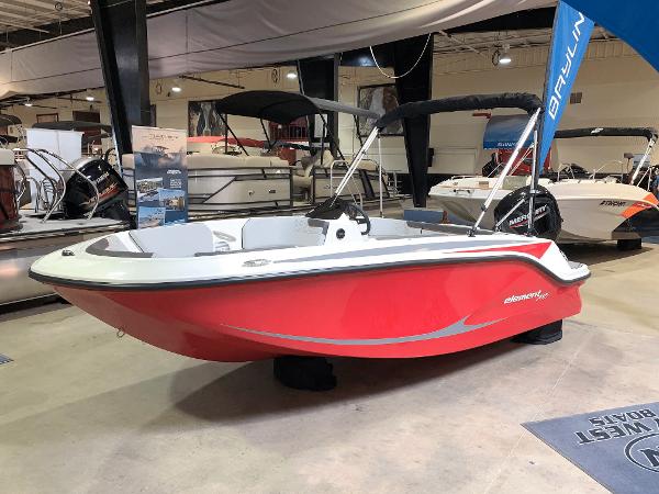 Slide: The Image of 2024 Bayliner Element M15 boat in showroom, red hull, black canopy, modern design. - 0