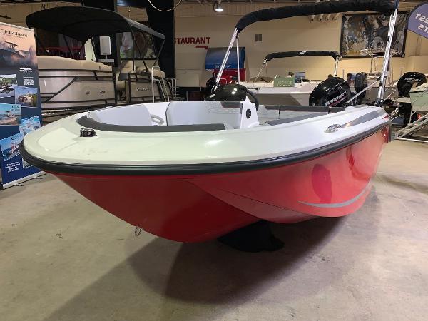 Slide: The Image of 2024 Bayliner Element M15 boat with red hull on display indoors. - 1