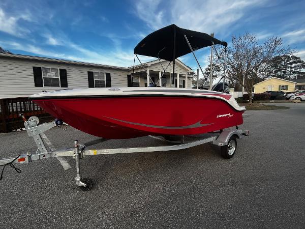 Slide: The Image of 2024 Bayliner Element M15 boat on a trailer in a residential area. - 1
