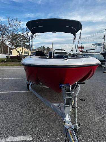 Slide: The Image of 2024 Bayliner Element M15 boat with red hull on trailer. - 2