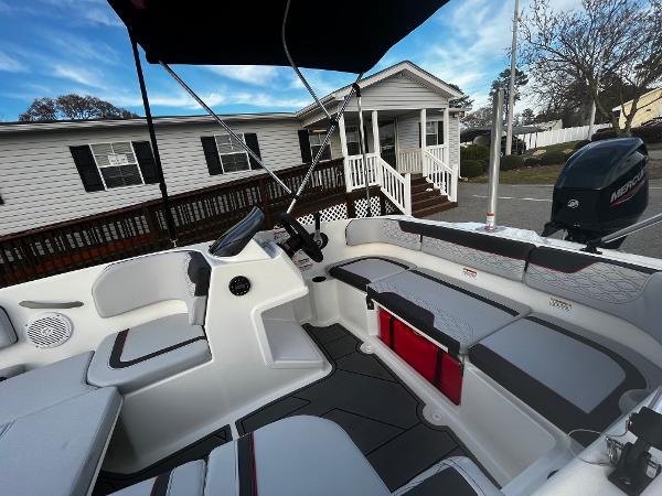 Slide: The Image of 2024 Bayliner Element M15 boat interior with seating and steering console. - 7