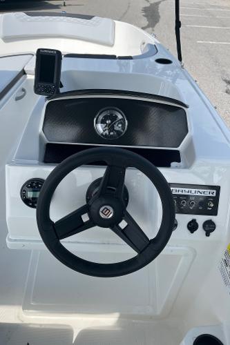 Slide: The Image of 2024 Bayliner Element M17 boat dashboard with steering wheel and instrument panel. - 14