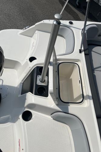 Slide: The Image of 2024 Bayliner Element M17 boat interior with storage compartment and cup holders. - 15