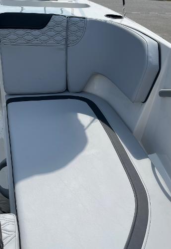 Slide: The Image of 2024 Bayliner Element M17 boat interior seating with white and gray upholstery. - 7