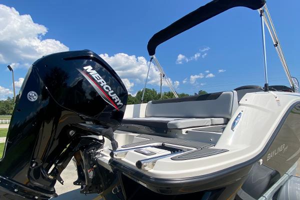 Slide: The Image of 2024 Bayliner Element M19 boat with Mercury outboard motor under a clear blue sky. - 5