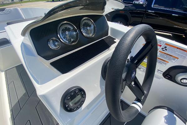 Slide: The Image of 2024 Bayliner Element M19 boat dashboard with steering wheel and gauges. - 8