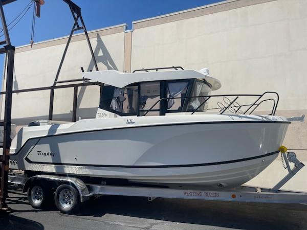 Slide: The Image of 2024 Bayliner Trophy 23 Pilothouse boat on a trailer. - 0