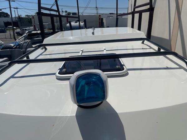 Slide: The Image of 2024 Bayliner Trophy 23 Pilothouse roof with blue light and hatch. - 10