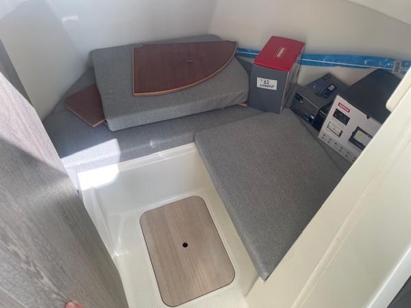 Slide: The Image of 2024 Bayliner Trophy 23 Pilothouse cabin interior with cushions and storage. - 11