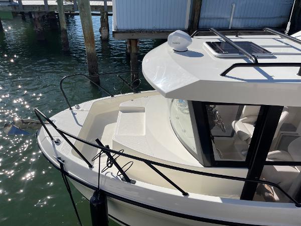 Slide: The Image of 2024 Bayliner Trophy 23 Pilothouse boat docked by the pier. - 2