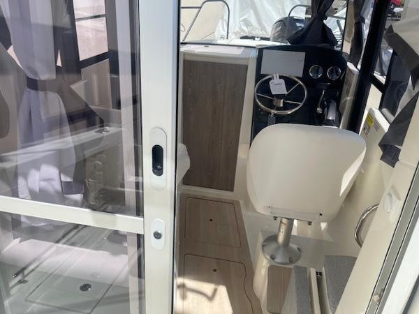 Slide: The Image of Interior of 2024 Bayliner Trophy 23 Pilothouse boat with helm and seating. - 20