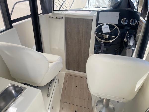 Slide: The Image of 2024 Bayliner Trophy 23 Pilothouse interior with helm and seating. - 21