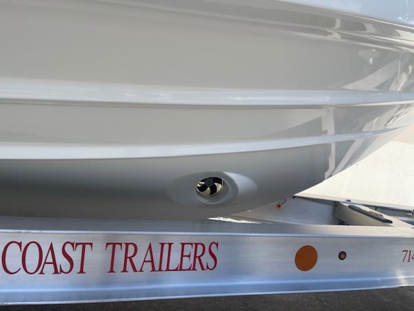 Slide: The Image of 2024 Bayliner Trophy 23 Pilothouse boat on Coast Trailers. - 24