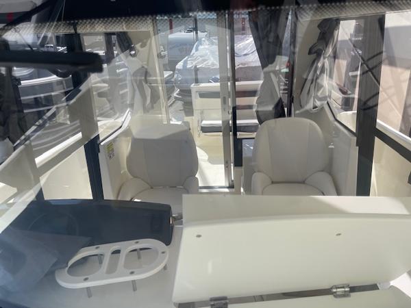 Slide: The Image of Interior of 2024 Bayliner Trophy 23 Pilothouse boat with seating and helm station. - 4