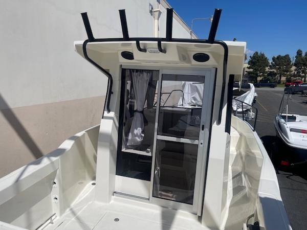Slide: The Image of 2024 Bayliner Trophy 23 Pilothouse boat exterior with sliding door. - 6