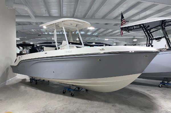 Slide: The Image of 2024 Bayliner Trophy 24 CC boat in showroom, side view. - 0