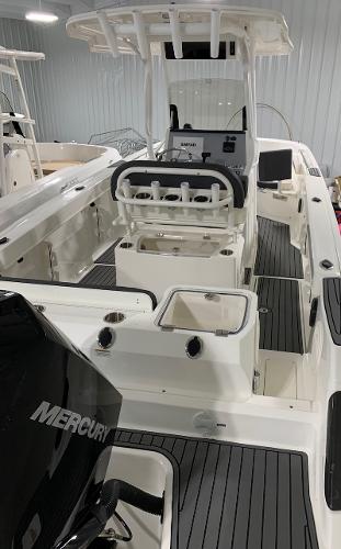Slide: The Image of 2024 Bayliner Trophy 24 CC center console boat with Mercury engine in showroom. - 1