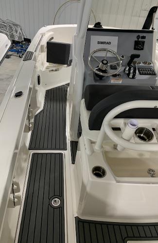 Slide: The Image of 2024 Bayliner Trophy 24 CC center console boat interior with steering wheel and controls. - 11