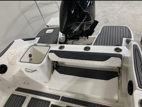 Slide: The Image of 2024 Bayliner Trophy 24 CC boat interior with seating and outboard motor. - 13