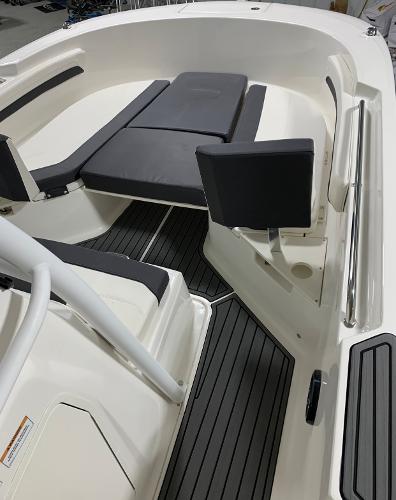 Slide: The Image of 2024 Bayliner Trophy 24 CC boat interior with cushioned seating and non-slip flooring. - 2