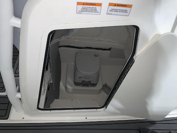 Slide: The Image of 2024 Bayliner Trophy 24 CC boat interior compartment with portable toilet. - 7