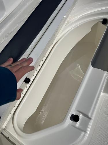 Slide: The Image of 2023 Bayliner Trophy T24 boat storage compartment with open lid. - 4