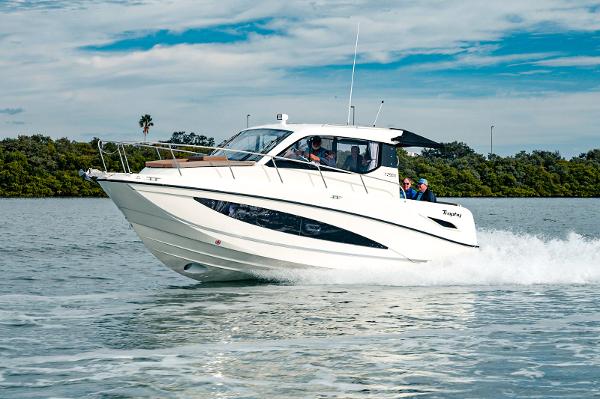 Slide: The Image of 2024 Bayliner Trophy T29EX cruising on water, showcasing sleek design and performance. - 1
