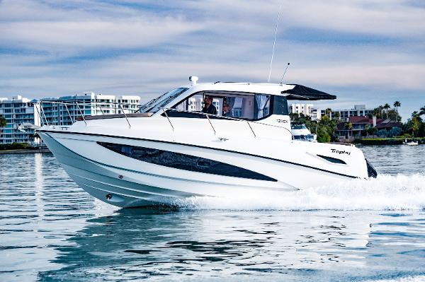 Slide: The Image of 2024 Bayliner Trophy T29EX cruising on water, modern design, cityscape background. - 10