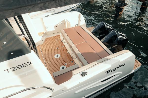 Slide: The Image of 2024 Bayliner Trophy T29EX boat with dual Mercury engines, featuring spacious deck seating. - 3