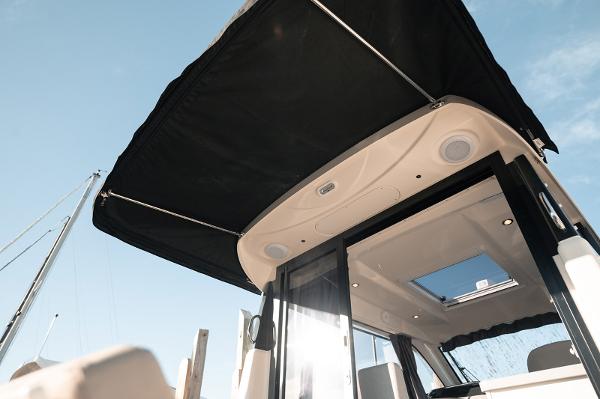 Slide: The Image of 2024 Bayliner Trophy T29EX boat canopy and cabin entrance under clear sky. - 9