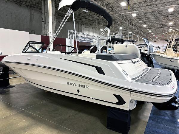 Slide: The Image of 2024 Bayliner VR5 boat displayed indoors at a showroom. - 1
