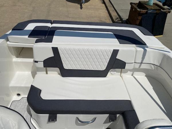 Slide: The Image of 2024 Bayliner VR5 boat interior with white and black seating. - 14