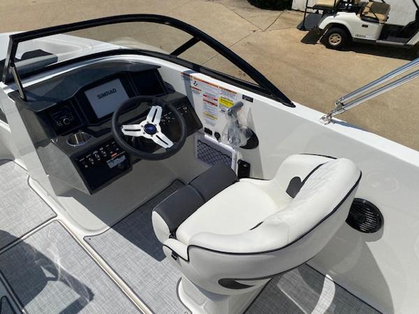 Slide: The Image of 2024 Bayliner VR5 boat cockpit with steering wheel and captain's chair. - 17