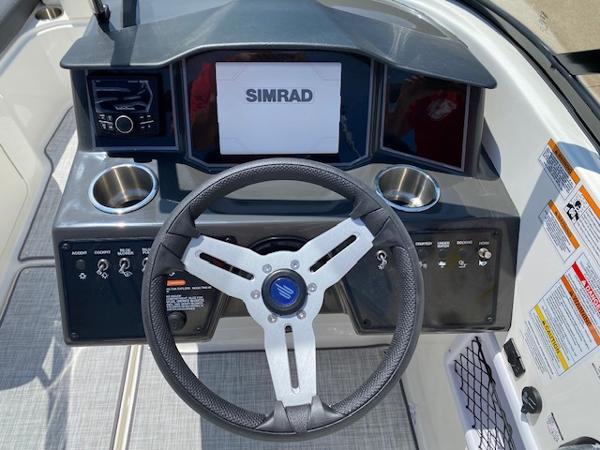 Slide: The Image of 2024 Bayliner VR5 boat dashboard with Simrad display and steering wheel. - 19
