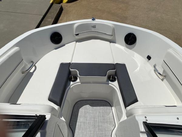 Slide: The Image of 2024 Bayliner VR5 boat interior with cushioned seating and cup holders. - 23