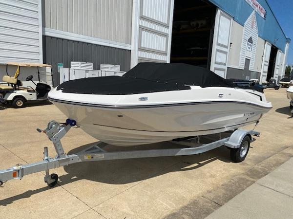Slide: The Image of 2024 Bayliner VR5 boat on trailer, covered, parked outside a warehouse. - 3