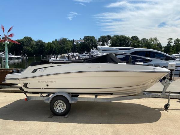 Slide: The Image of 2024 Bayliner VR5 boat on trailer at marina, sunny day. - 4