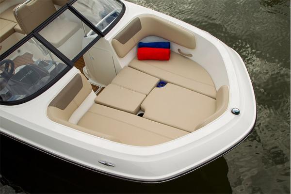Slide: The Image of 2023 Bayliner VR5 Bowrider boat with beige seating and red-blue cushion. - 11