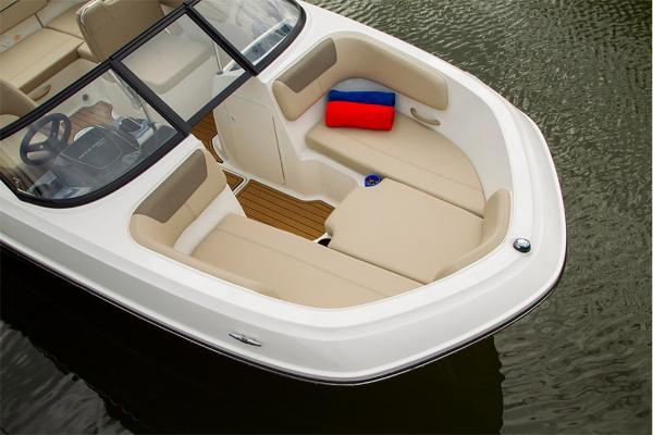 Slide: The Image of 2023 Bayliner VR5 Bowrider boat with beige seating and red-blue cushion on water. - 12