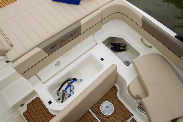 Slide: The Image of 2023 Bayliner VR5 Bowrider boat interior with storage compartments and seating. - 13