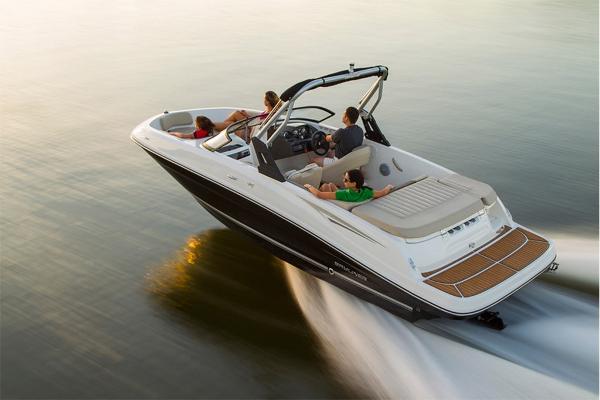 Slide: The Image of 2023 Bayliner VR5 Bowrider cruising on water with passengers. - 2
