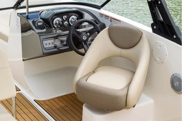 Slide: The Image of 2023 Bayliner VR5 Bowrider cockpit with steering wheel and captain's chair. - 22