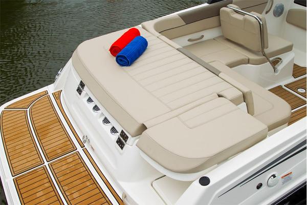 Slide: The Image of 2023 Bayliner VR5 Bowrider with beige seating and swim platform, featuring red and blue towels. - 23