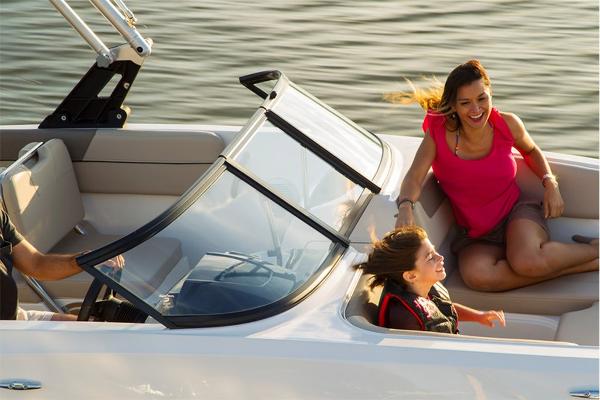 Slide: The Image of 2023 Bayliner VR5 Bowrider with family enjoying a sunny day on the water. - 4