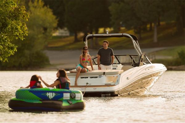Slide: The Image of 2023 Bayliner VR5 Bowrider on a lake with people enjoying water activities. - 5