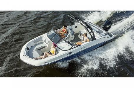 Slide: The Image of 2023 Bayliner VR6 Bowrider Outboard cruising on water with passengers. - 2