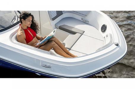 Slide: The Image of 2023 Bayliner VR6 Bowrider Outboard with woman relaxing in bow seating area. - 6