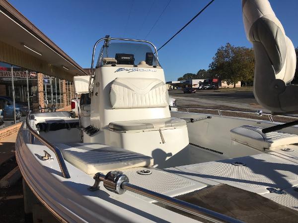 Slide: The Image of 2005 Bay Stealth 2030 Liner boat with white interior, parked outdoors. - 3