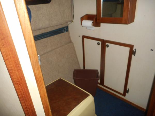 Slide: The Image of 1984 Beachcraft Cabin Cruiser interior with storage cabinets and mirror. - 16